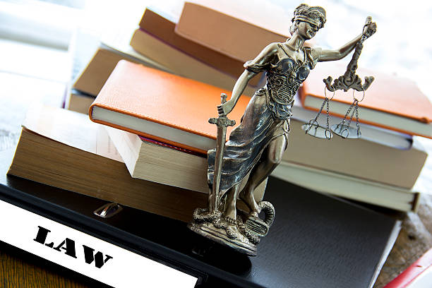 Justice statue with sword and scale and books. Law concept stock photo