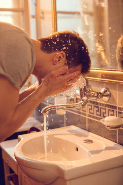 istock Young man washing face in the morning. 512893576