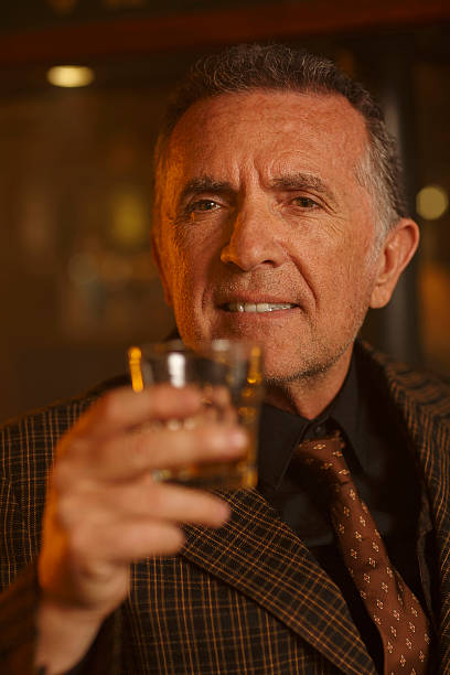 istock Portrait Retro romantic Old fashioned senior man drinking whiskey 512894684