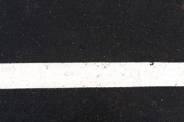 istock White traffic line on asphalt road. 512897404