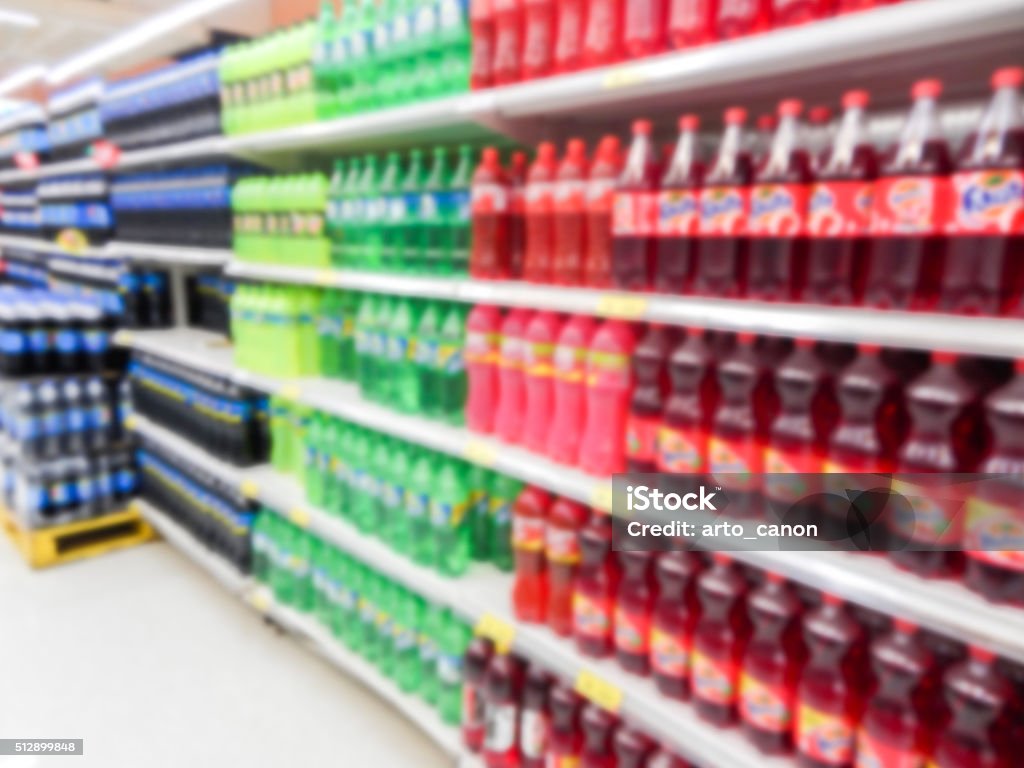 Drink bottles on display on shelves in a supermarket Drink bottles on display on shelves in a supermarket blur background Soda Stock Photo