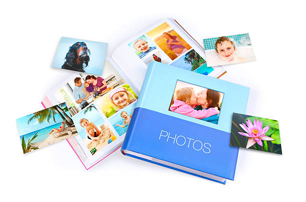 Family photo albums and various photos around Family photo albums and various photos isolated on white printing out photos stock pictures, royalty-free photos & images