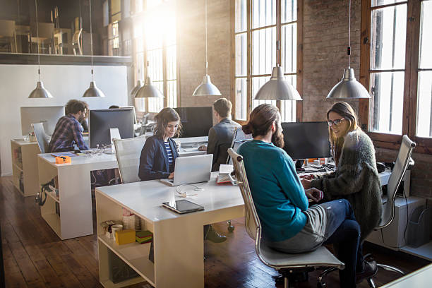 Young creative business people working in the office Young creative business people working in the office late in the afternoon. 20 29 years stock pictures, royalty-free photos & images