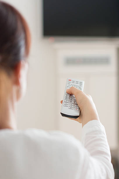 istock Woman in home watching television 512901216