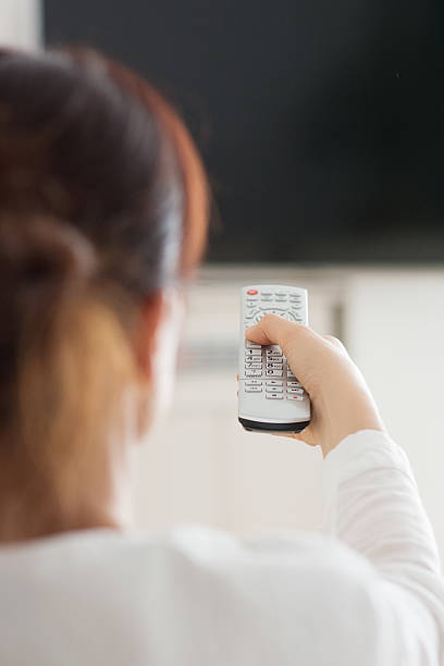 istock Woman in home watching television 512901368