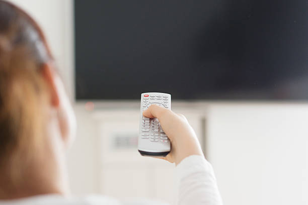 istock Woman in home watching television 512901600