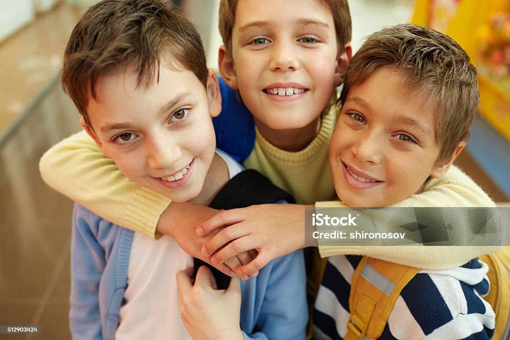 Best friends Portrait of three happy embracing boys Close-up Stock Photo