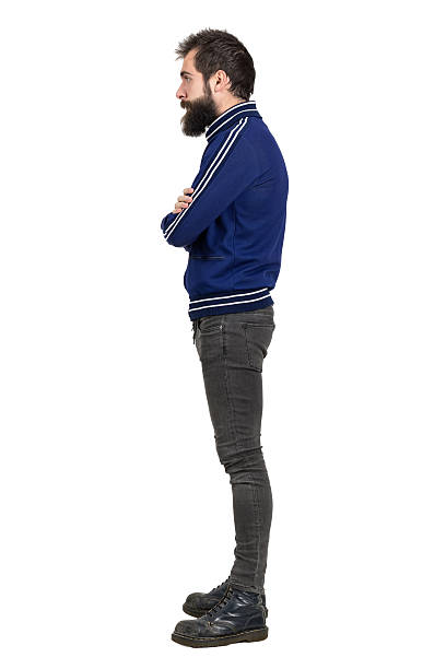 istock Side view of young bearded punker in tracksuit looking away 512906276