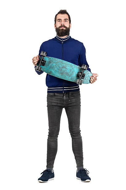 istock Proud bearded hipster carrying and showing skateboard to camera 512906544