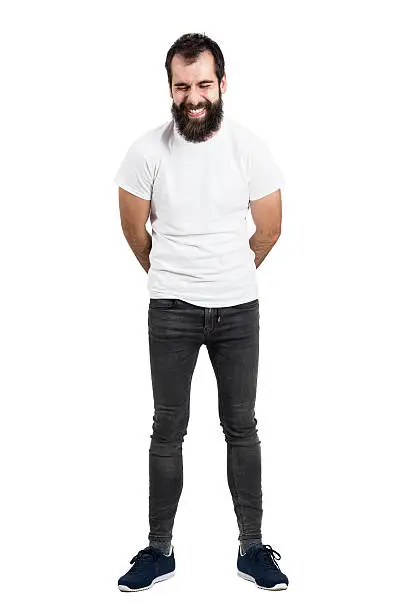 Photo of Spontaneously laughing bearded man with hands on back