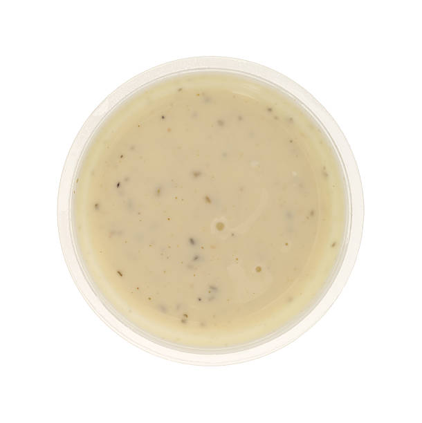 istock Container of ranch dressing on a white background top view 512908070