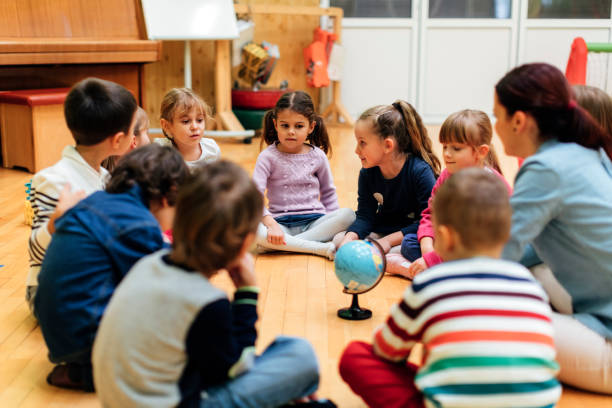 istock Preschool teacher and children in classroom 512908274