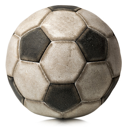 Detail of a old black and white soccer ball isolated on white background