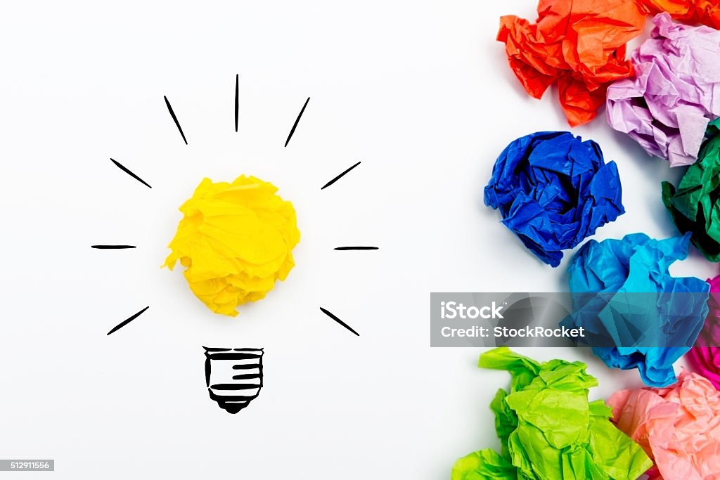 I have an Idea Crumpled paper light bulb over white background, surrounded by crumpled colorful paper. Idea concept. White Background Stock Photo