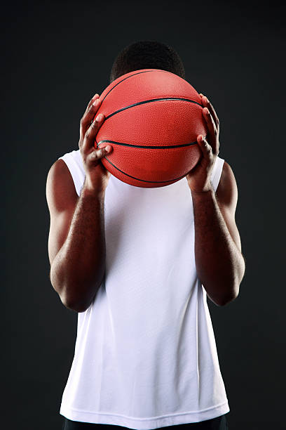 istock Basketball player holding a ball 512918255