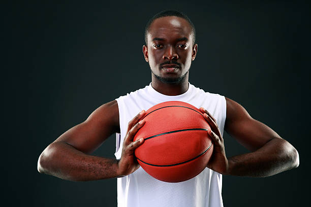 istock African man holding basketball ball 512918275