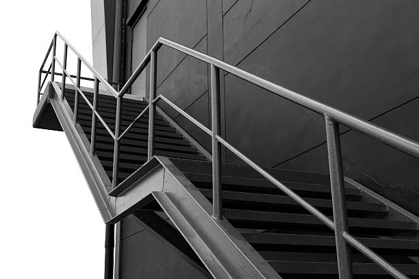 istock Metal fire escape on Black Building With Isolated White Background 512918409