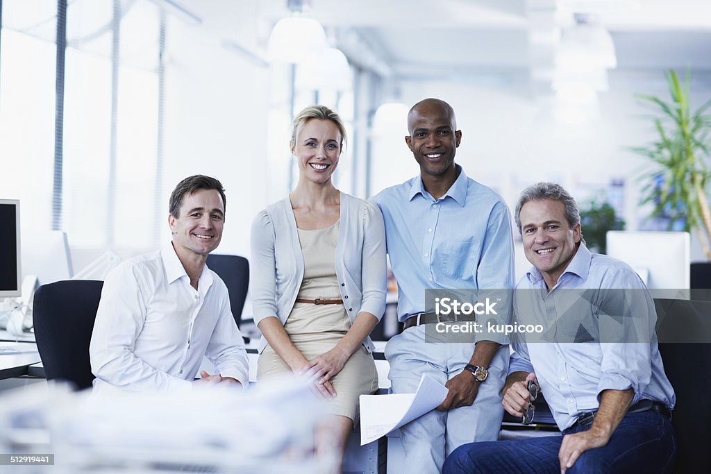 They are a total business team Portrait of a group of smiling businesspeople in an office Adult Stock Photo