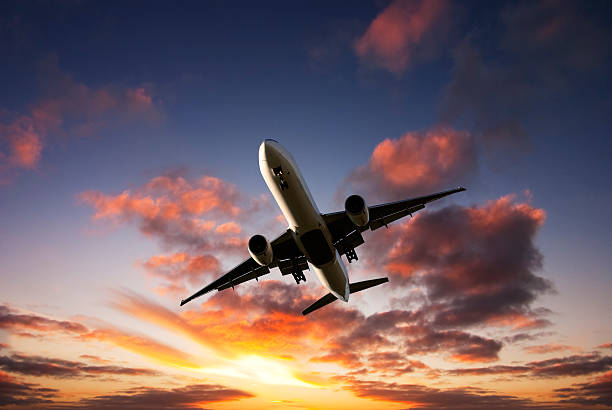 istock Jet Aeroplane Landing From Bright Sunset Sky 512919863