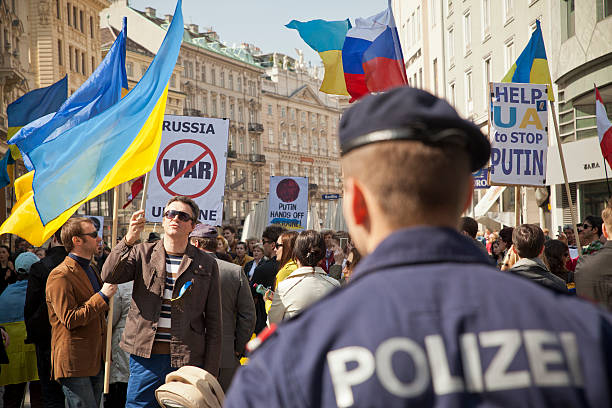 Ukraine and Russia Protests Vienna, Austria - March 30, 2014: Protesters gather in the main square in Vienna to protest the Russian annexation of Crimea from Ukraine. Police are watching the protests carefully in the background. russian culture photos stock pictures, royalty-free photos & images