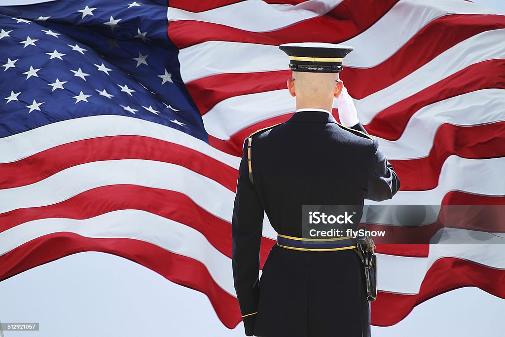 Soldier's Saluting Flag and soldiers saltine. USA Stock Photo