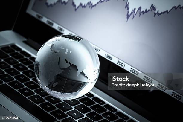 Globe On Laptop Keyboard With Chart In The Background Stock Photo - Download Image Now