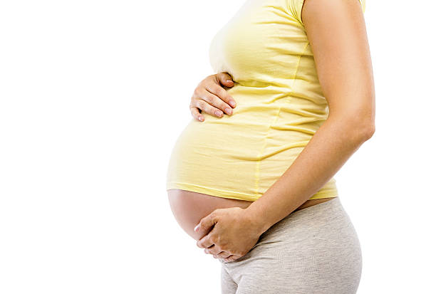 istock Unrecognizable pregnant woman isolated on white 512922185