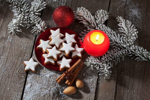 Cinnamon stars with Christmas decoration on wooden background