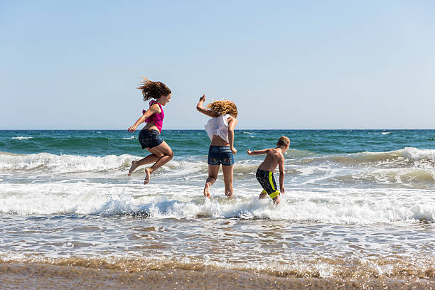 istock Brother and Sisters Enjoy a Day on the Beach 512922515