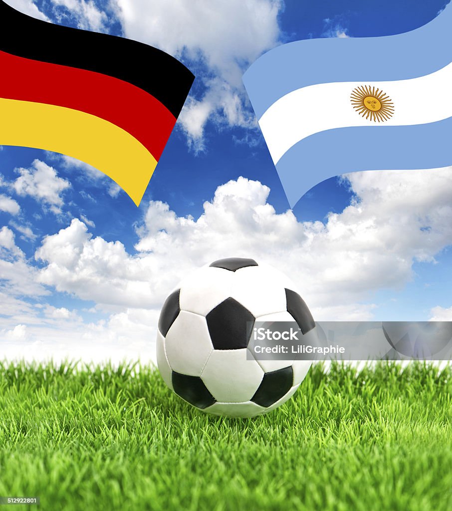 Soccer ball on grass and flags of Germany and Argentina Soccer ball on green grass and national flags of Germany and Argentina over dramatic blue sky. Collage Argentina Stock Photo