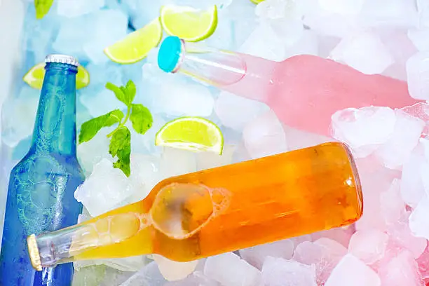 Photo of chilled colorful beverages in ice box. summer party