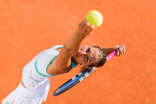 istock Young woman playing tennis 512936581