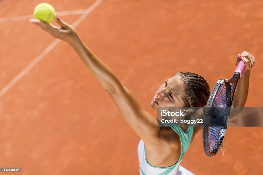 Young woman playing tennis Activity Stock Photo