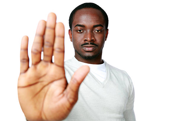 istock african man showing stop sign with hand 512937901