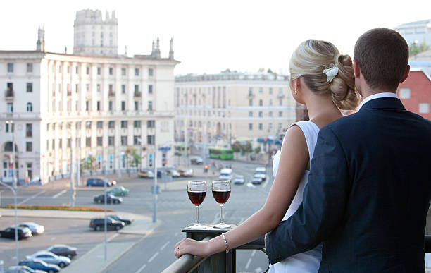Couple with a glass of wine watching the city.