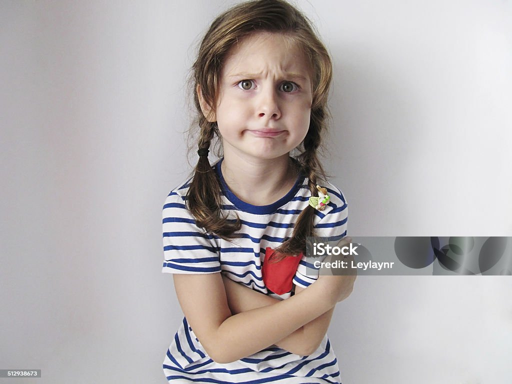 Angry and cute girl Angry girl looking at the camera. Child Stock Photo