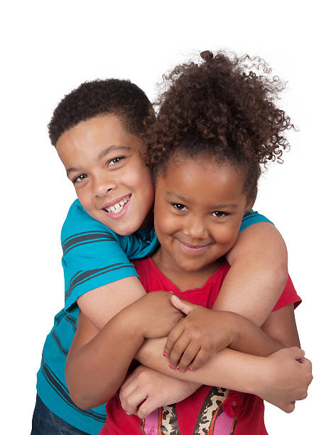 African-Canadian Siblings Hugging stock photo