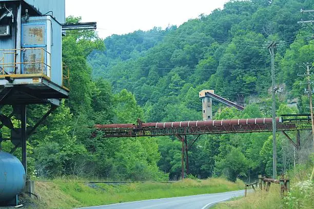 Coal tipple with several conveyor belts and chutes running over and beside the highway, located in Southeastern Kentucky.