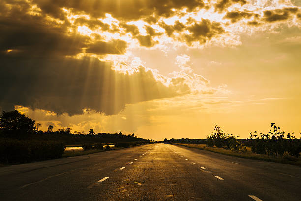 istock Road to Havana with the sun breaking through dark clouds 512941081