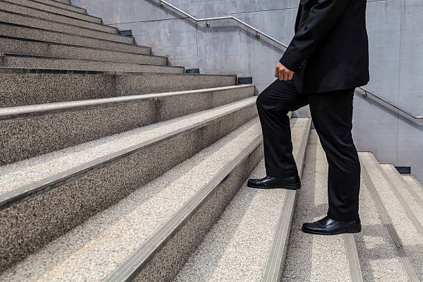 istock businessman walk up on stair background 512958833