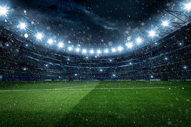 istock Dramatic football stadium with rain and snow 512959561