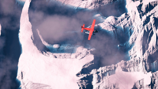 Aerial of red airplane flying over arctic snow landscape with blue water.