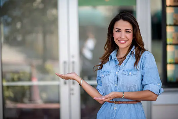 Happy business owner in front of her shop