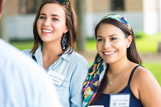 istock Young women touring beautiful college campus with tour guide 512962893