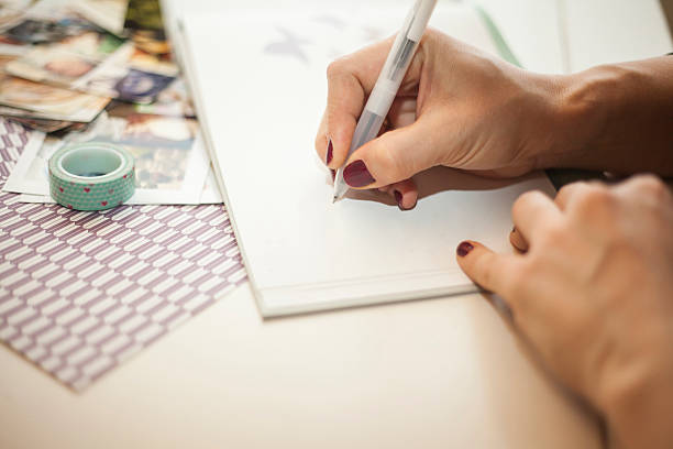 istock Woman writing in a baby book 512966578