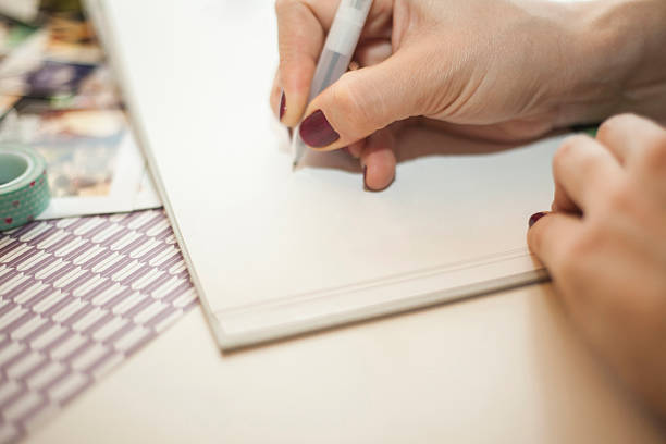 istock Woman writing in a baby book 512966674