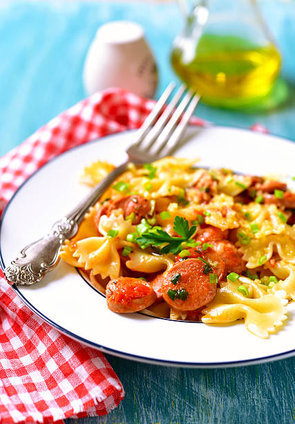 istock Farfalle with sausage in tomato sauce. 512967608