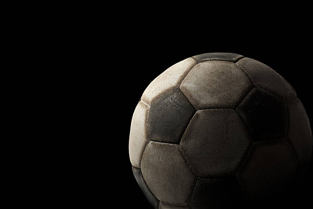 古いサッカーボールを黒の背景 - soccer ball old leather soccer ストックフォトと画像