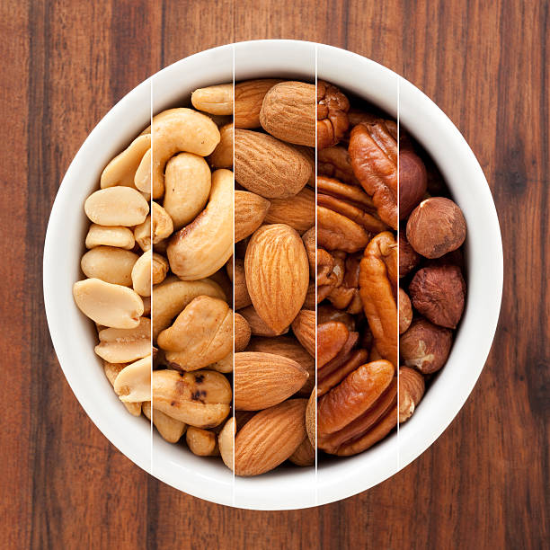 a guscio composizione - peanut bowl nut circle foto e immagini stock