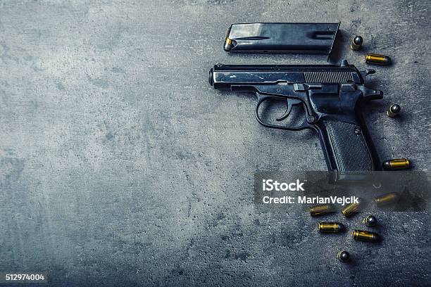 9mm Pistol Gun And Bullets Strewn On The Table Stock Photo - Download Image Now - Gun, Backgrounds, Safety